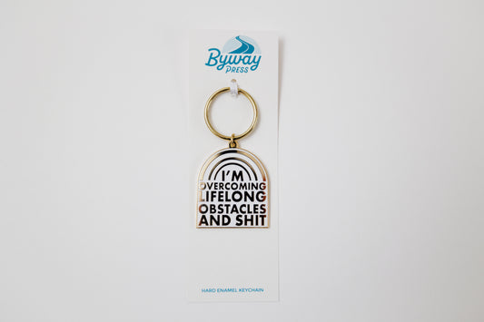 Overcoming Lifelong Obstacles Enamel Keychain